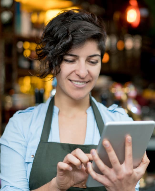 female waitstaff using a tablet