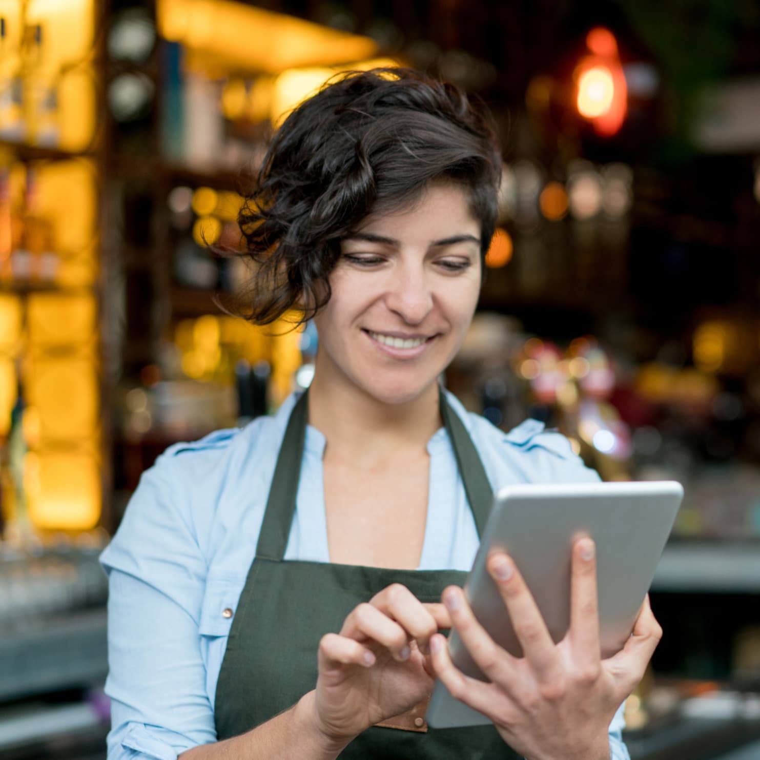 female waitstaff using a tablet
